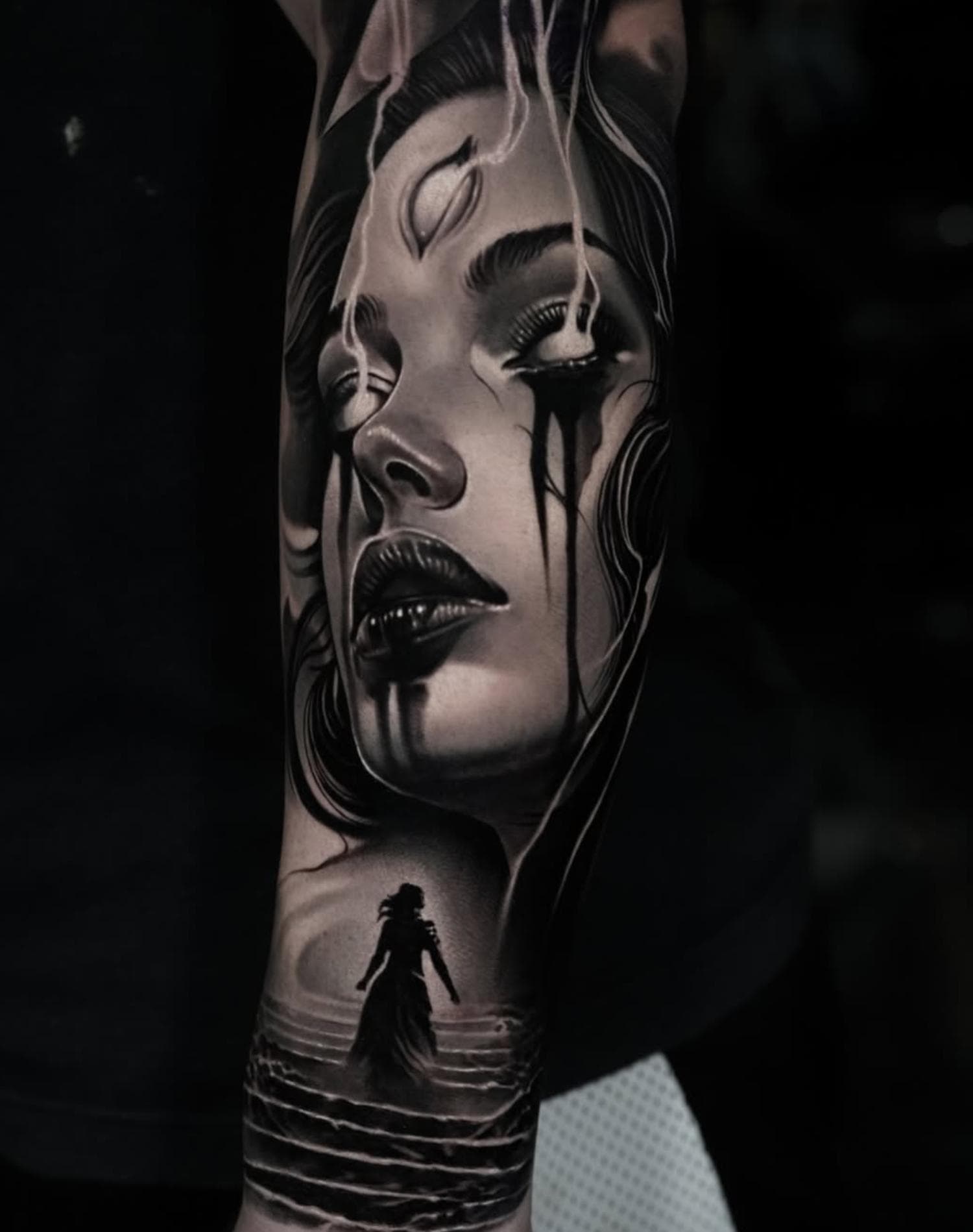 Black and grey realistic female portrait full sleeve on arm