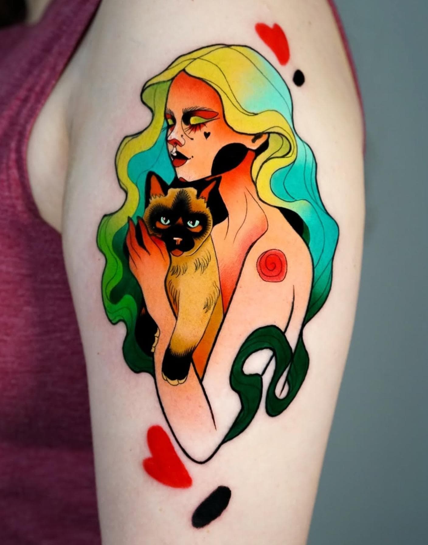 Colorful New School tattoo of a woman with a cat on the upper arm