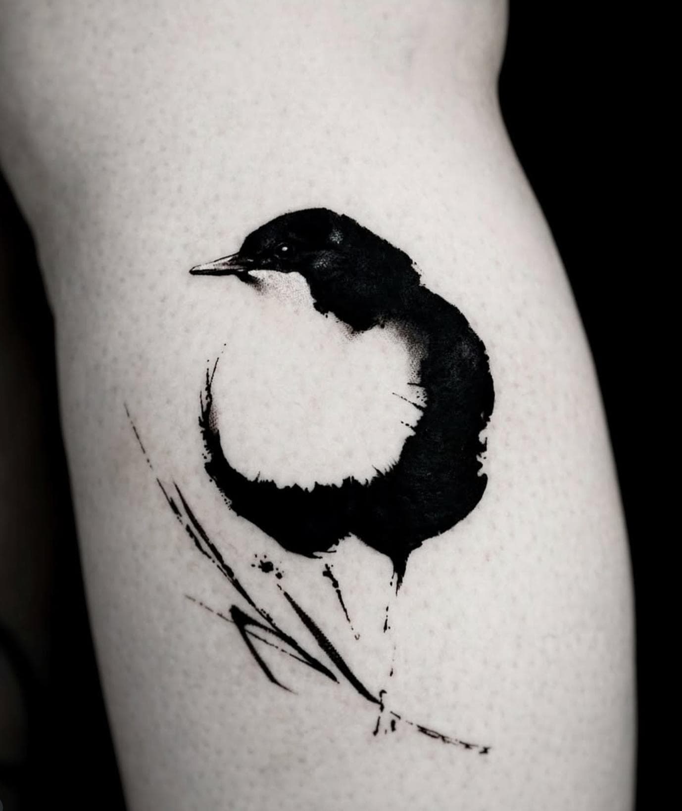 Blackwork minimalist abstract bird tattoo on upper arm