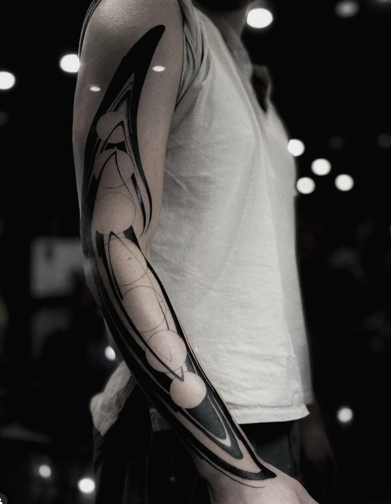 Black and grey geometric full sleeve tattoo on arm