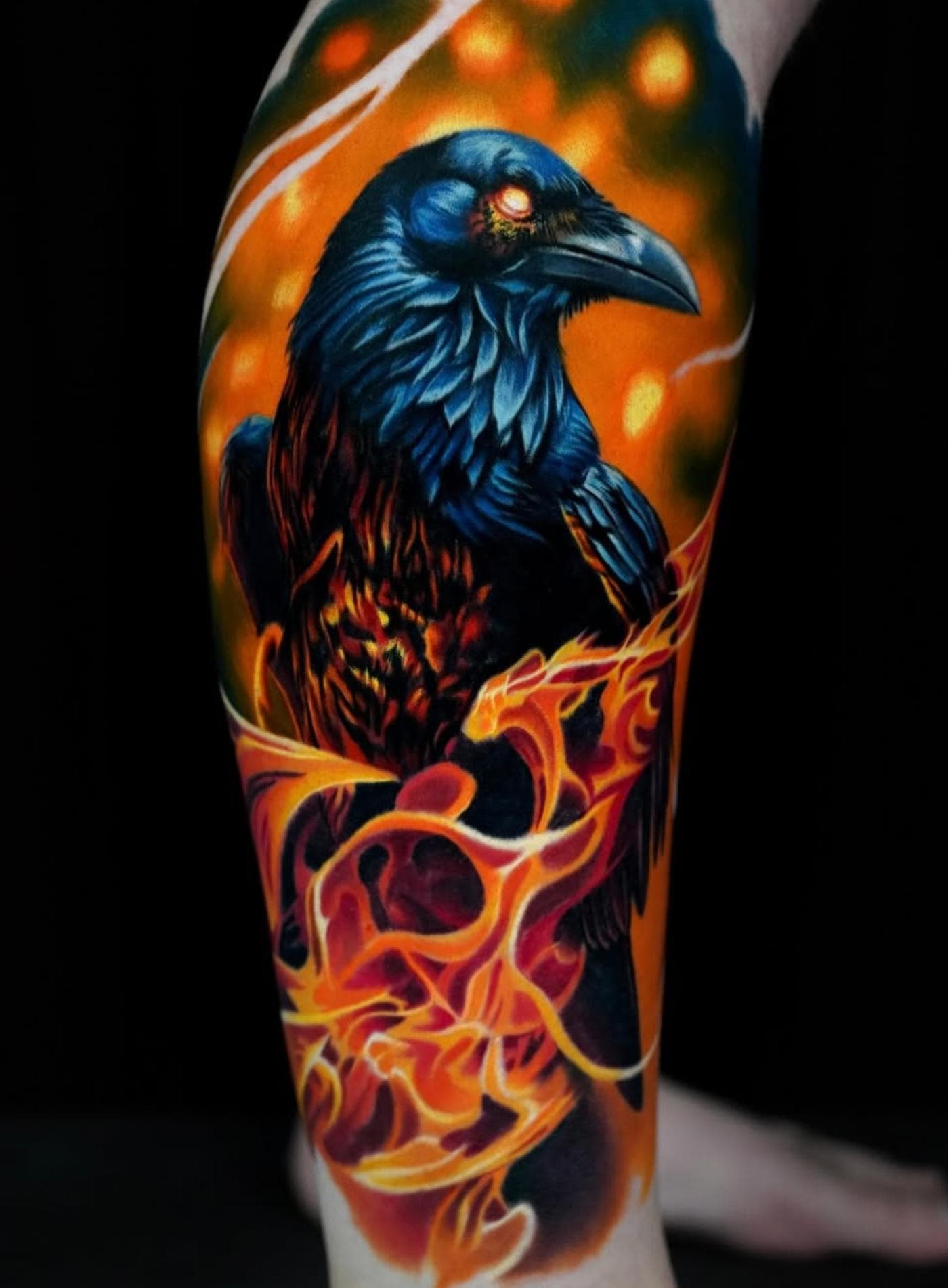 Colorful raven tattoo with flames on calf