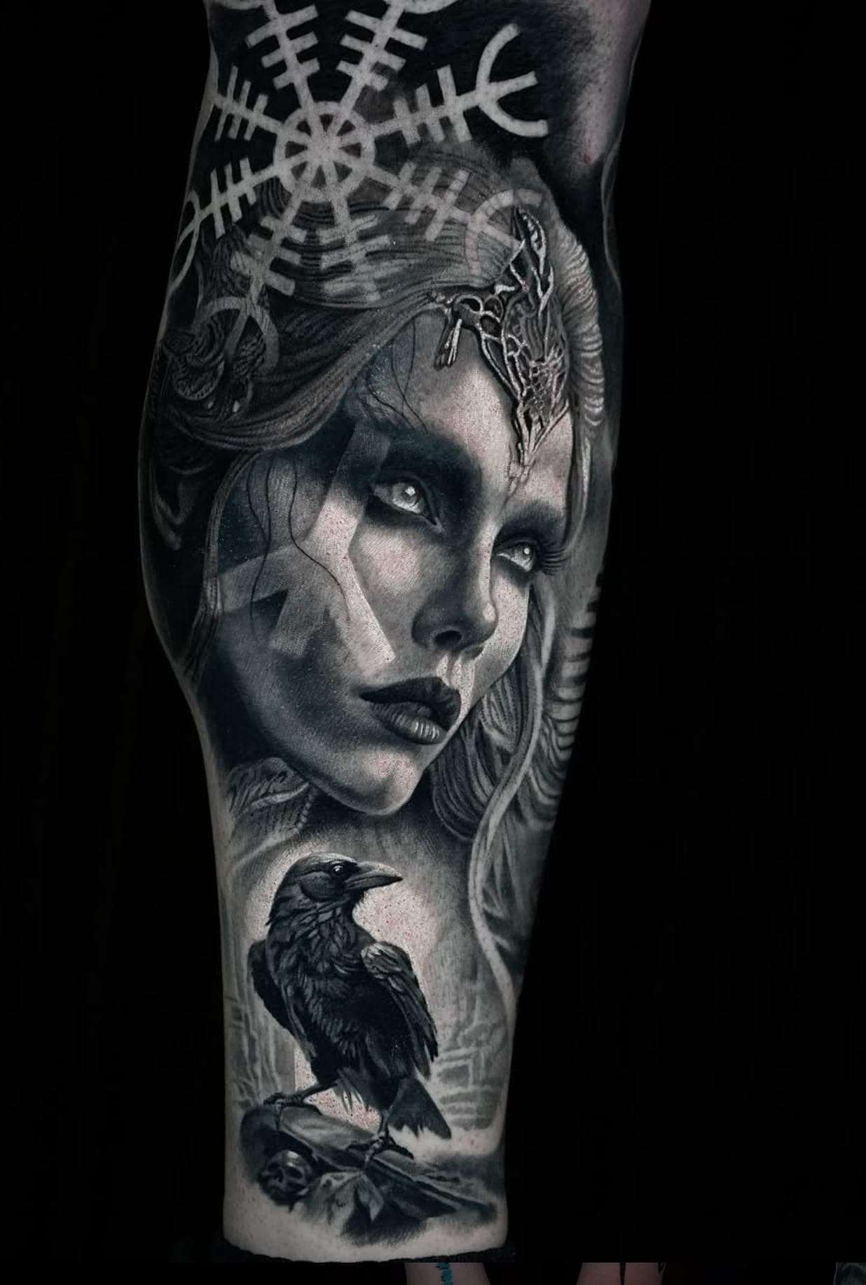 Black and grey realistic Norse woman and raven on forearm
